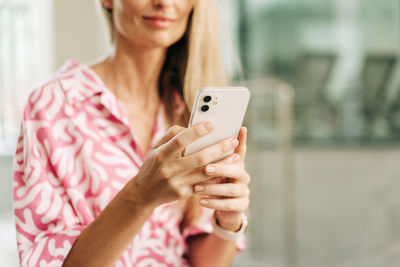Midsection of woman using mobile phone