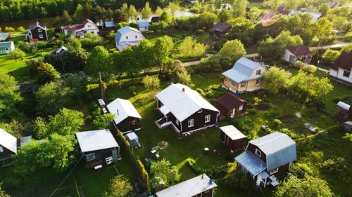 High angle view of buildings and trees on field