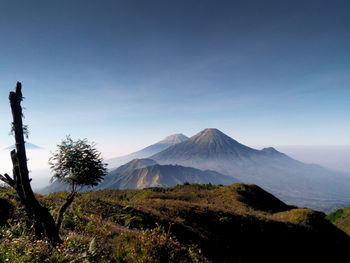 Scenic view of mountains against clear blue sky