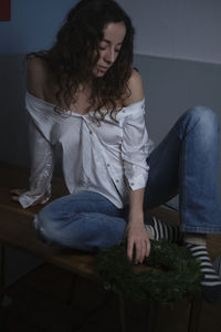 Young woman sitting at home