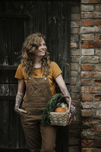 Full length of young woman standing in basket