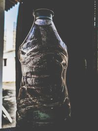 Close-up of glass bottle against black background