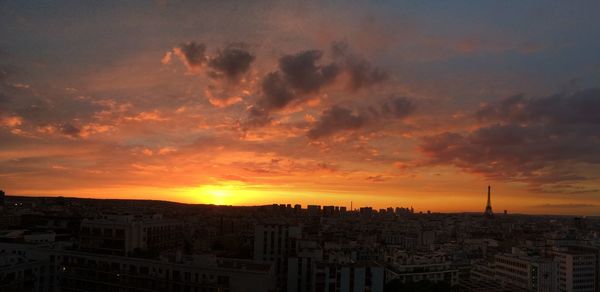 High angle view of buildings against cloudy sky during sunset