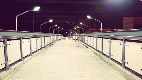 Illuminated railroad station platform at night