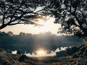 Scenic view of landscape and the sun rising in the morning