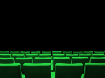 Empty chairs against black background