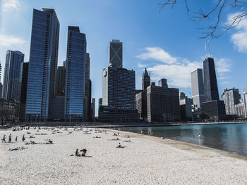 View of skyscrapers against cloudy sky