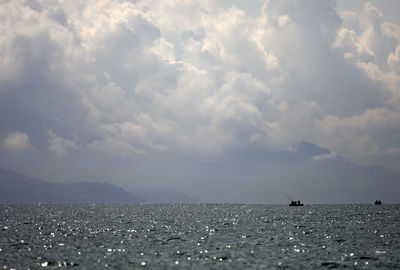 Scenic view of sea against cloudy sky