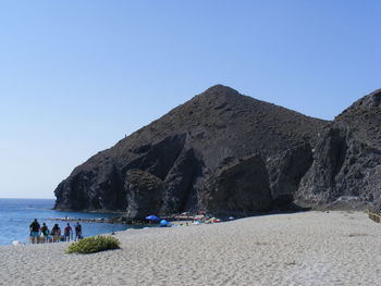 Scenic view of beach against clear blue sky