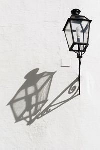 Close-up of lamp against wall