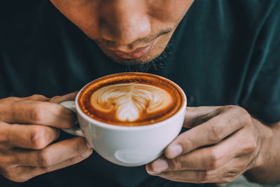 Midsection of man having coffee