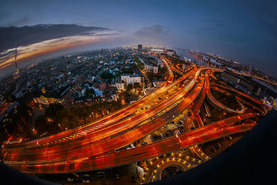 High angle view of illuminated city against sky at night