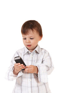 Boy using mobile phone against white background