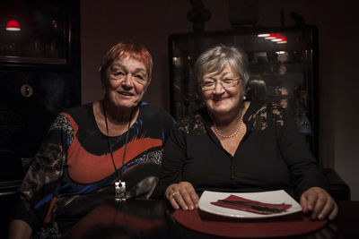 Portrait of smiling woman sitting at home