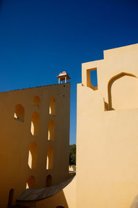 Low angle view of building against blue sky