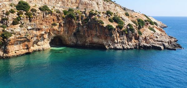 Scenic view of sea against rock formation