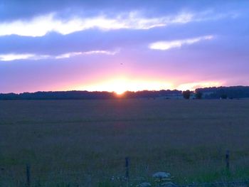 Scenic view of landscape against sky at sunset