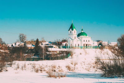 Buildings against blue sky during winter