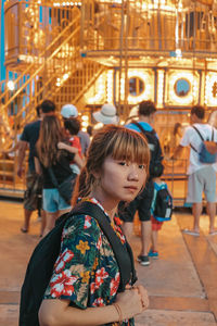 People in amusement park ride at night