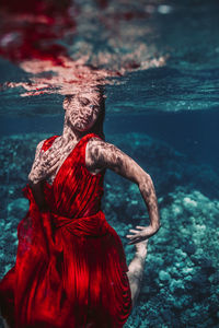 Midsection of woman in sea
