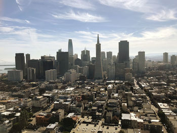 Aerial view of modern buildings in city against sky