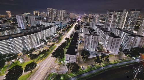 High angle view of street amidst buildings at night