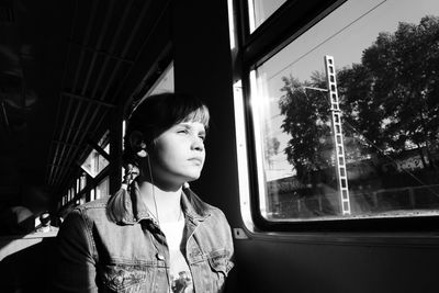 Teenage girl sitting in tram