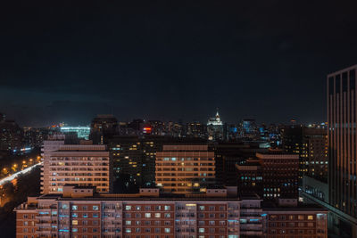 High angle view of illuminated buildings in city at night