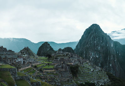 Old ruins of machu picchu against mountains during foggy weather