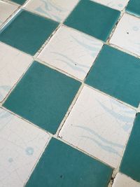 High angle view of tiled floor by swimming pool