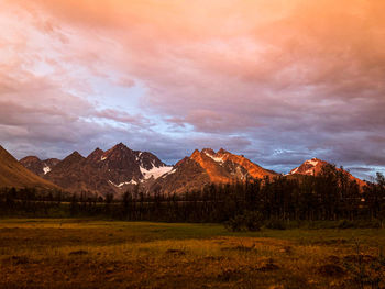 Scenic view of field against sky during sunset