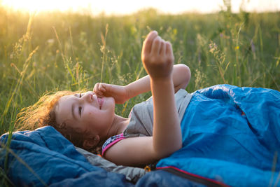 Portrait of woman lying on field