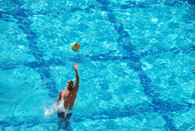 Man playing water sport in pool