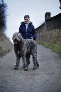 Full length of a woman and irish wolfhound