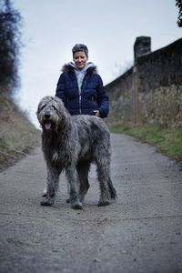 Full length of a boy playing with dog