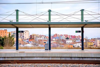 Train on railroad tracks in city against sky