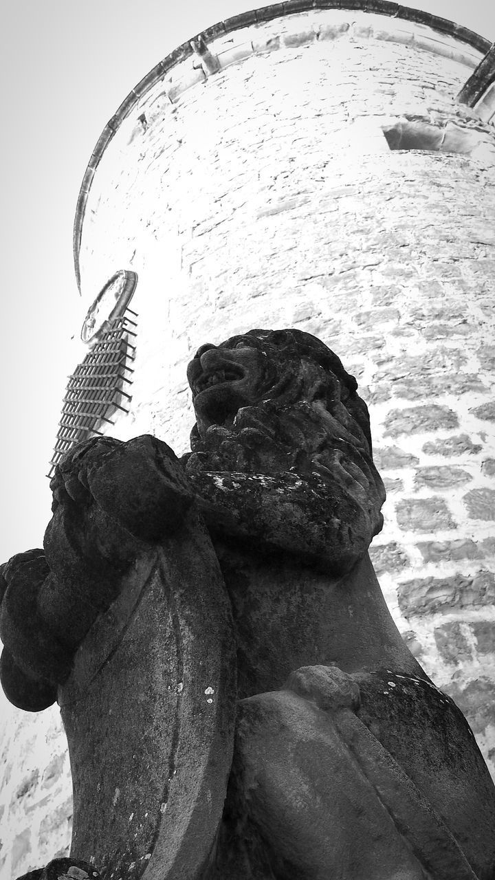 CLOSE-UP OF STATUE AGAINST SKY