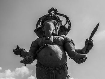 Low angle view of statue against sky