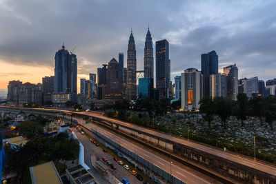 Aerial view of buildings in city against sky during sunset