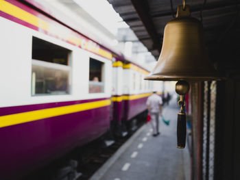 Close-up of bell by train at railroad station platform