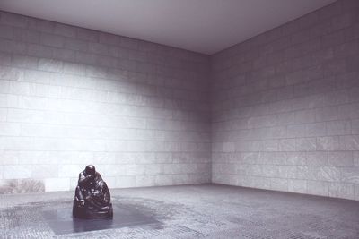 Garbage on floor against wall