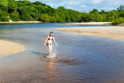 Side view of woman walking at beach