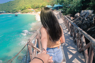 Midsection of woman at sea shore