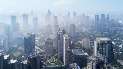 High angle view of modern buildings in city against sky