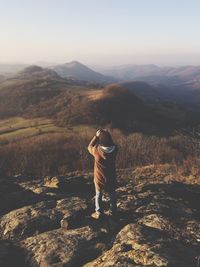 Man standing on mountain against clear sky