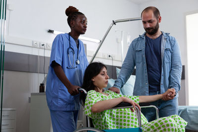 Portrait of doctor examining patient in hospital