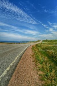 Dirt road passing through field