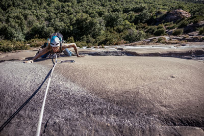 Overhead view of a girl climbing on a granite wall