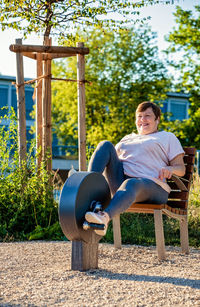 Side view of woman sitting on chair