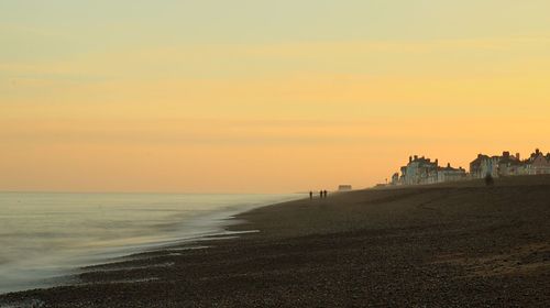 Scenic view of beach against sky during sunset